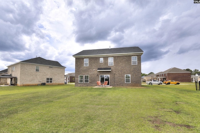 rear view of property featuring a patio, a gazebo, a yard, and brick siding