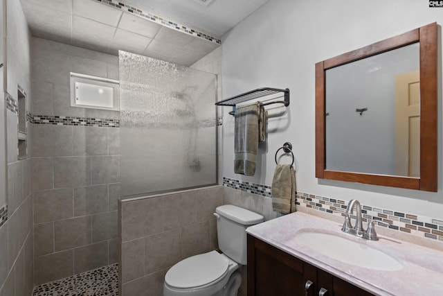 full bath featuring a walk in shower, toilet, and vanity