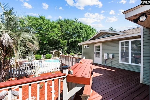 wooden deck featuring an outbuilding and a storage shed