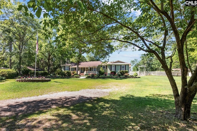 single story home featuring fence and a front lawn