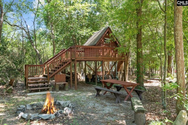 view of property's community featuring an outdoor fire pit and stairway
