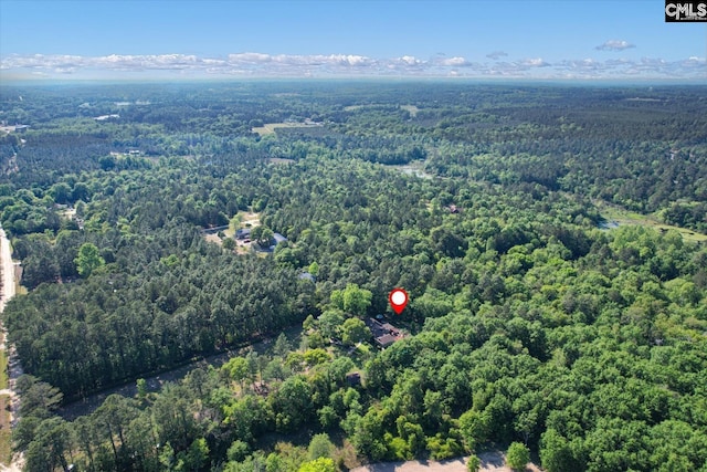 birds eye view of property with a wooded view