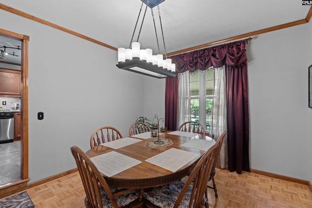dining room featuring baseboards, ornamental molding, and a notable chandelier