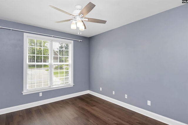 unfurnished room with baseboards, dark wood finished floors, and ceiling fan
