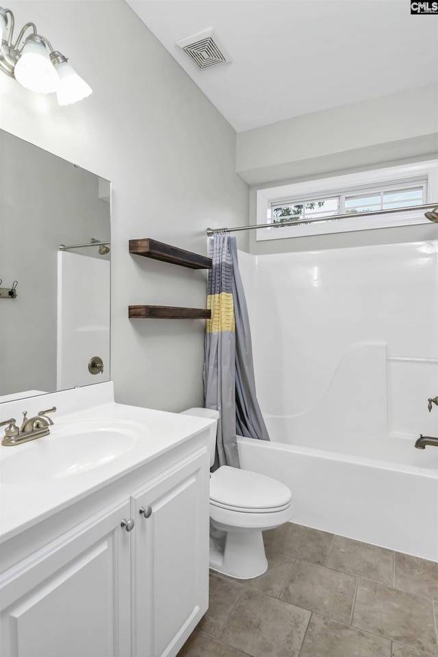 bathroom featuring vanity, toilet, visible vents, and shower / tub combo with curtain