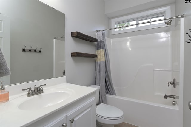 bathroom with vanity, shower / tub combo, and toilet