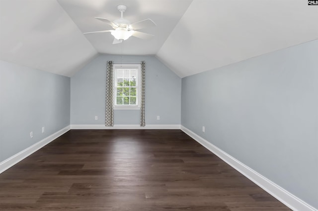 bonus room with dark wood-style flooring, ceiling fan, vaulted ceiling, and baseboards