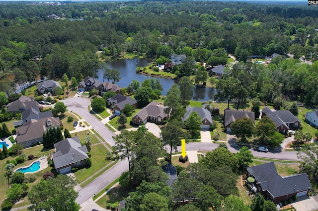 aerial view featuring a residential view, a water view, and a wooded view
