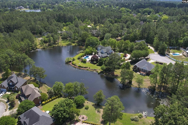 drone / aerial view with a water view and a wooded view