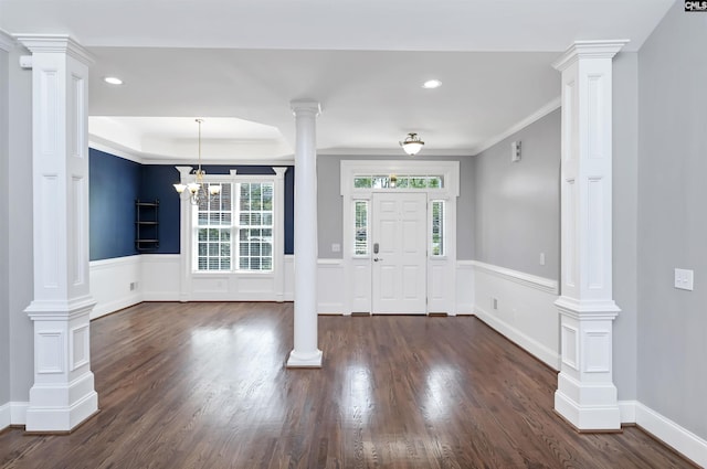 entrance foyer featuring recessed lighting, ornate columns, and dark wood-style floors