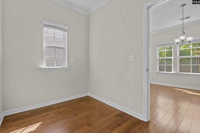 unfurnished room with crown molding, baseboards, dark wood finished floors, and visible vents