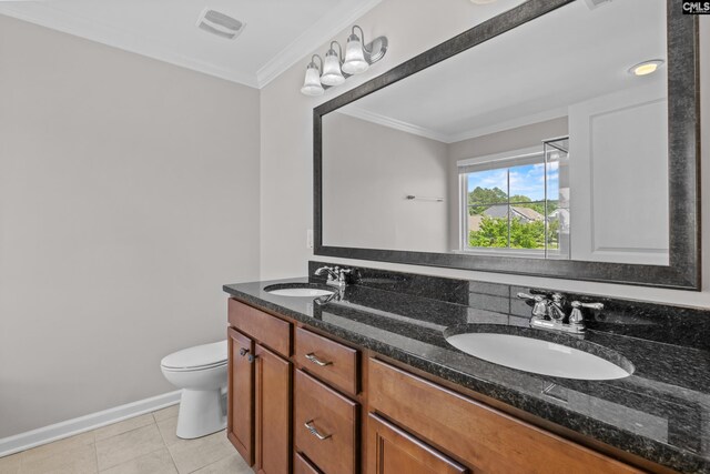 full bath featuring double vanity, a sink, toilet, and ornamental molding