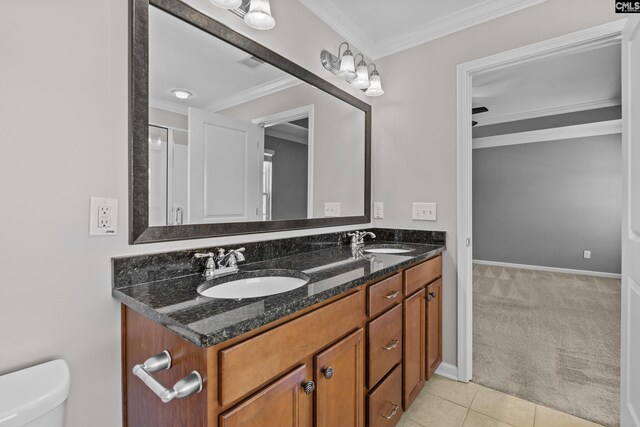 bathroom featuring a sink, tile patterned flooring, toilet, and double vanity