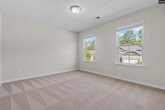 carpeted empty room with baseboards and visible vents