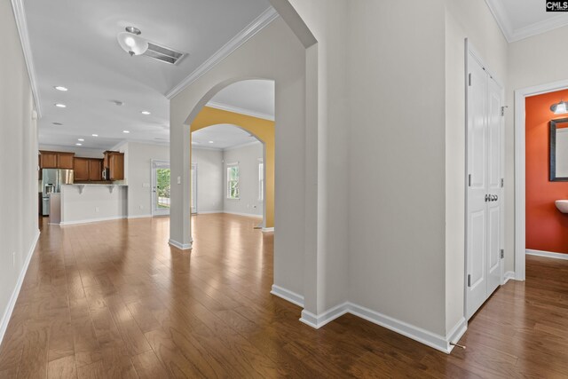interior space featuring recessed lighting, baseboards, ornamental molding, and hardwood / wood-style floors