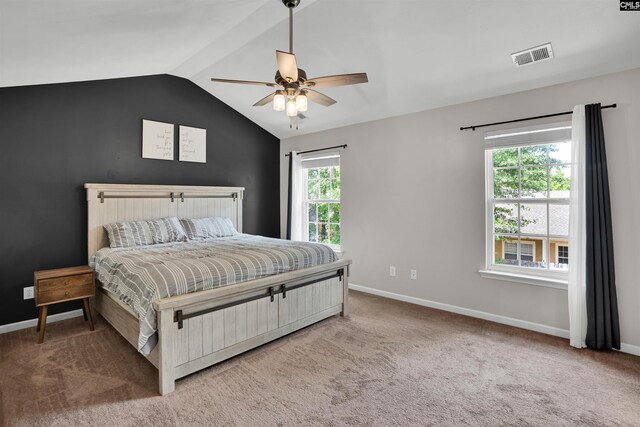 bedroom with ceiling fan, light colored carpet, baseboards, vaulted ceiling, and visible vents