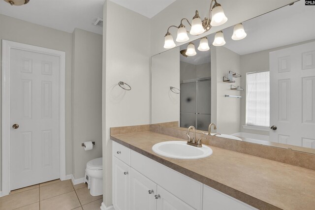 full bathroom featuring vanity, tile patterned floors, a stall shower, and toilet
