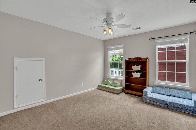 unfurnished room with carpet floors, ceiling fan, visible vents, and baseboards
