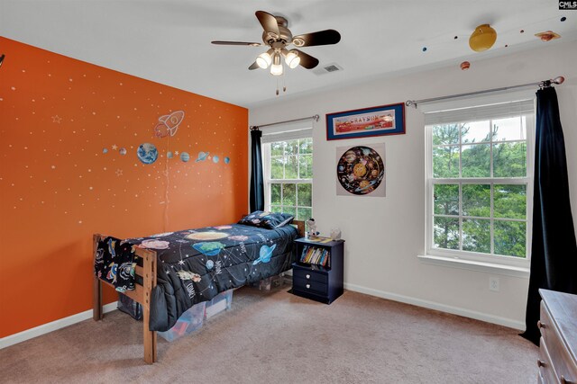 carpeted bedroom with a ceiling fan, baseboards, and visible vents