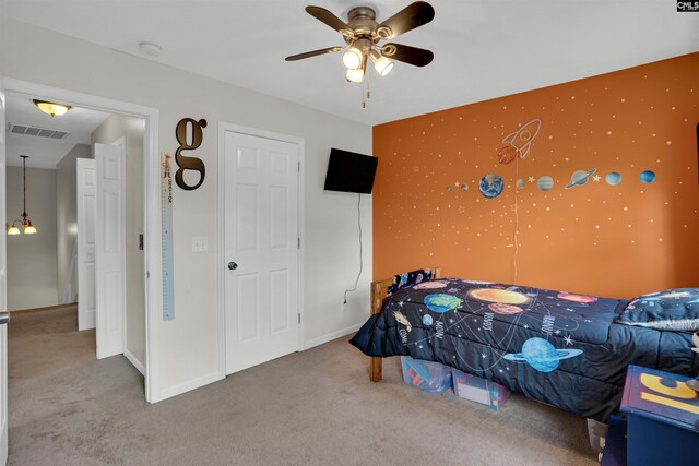 bedroom with visible vents, carpet, and ceiling fan