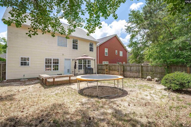 rear view of house with a fenced backyard