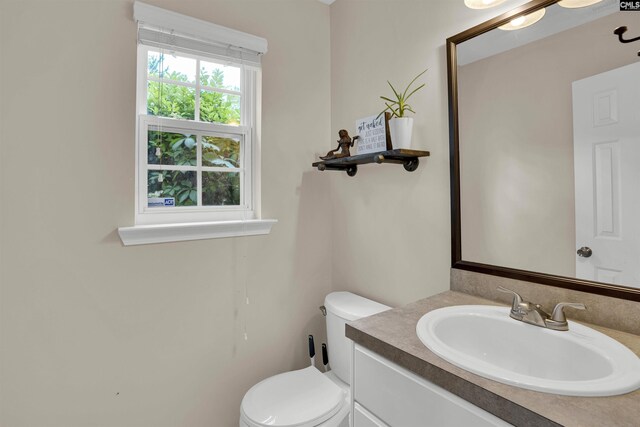 bathroom featuring toilet and vanity