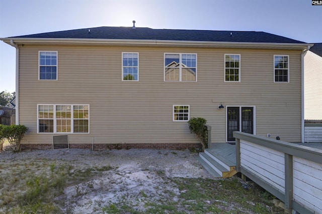 back of house with a deck