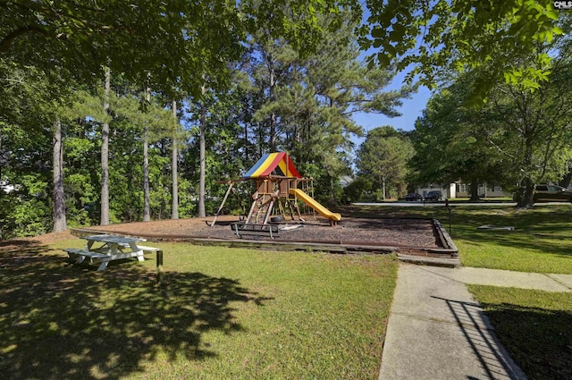 community jungle gym featuring a lawn