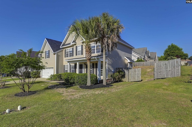 exterior space with a garage, fence, and a yard