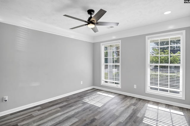 spare room with a ceiling fan, baseboards, recessed lighting, dark wood-type flooring, and visible vents