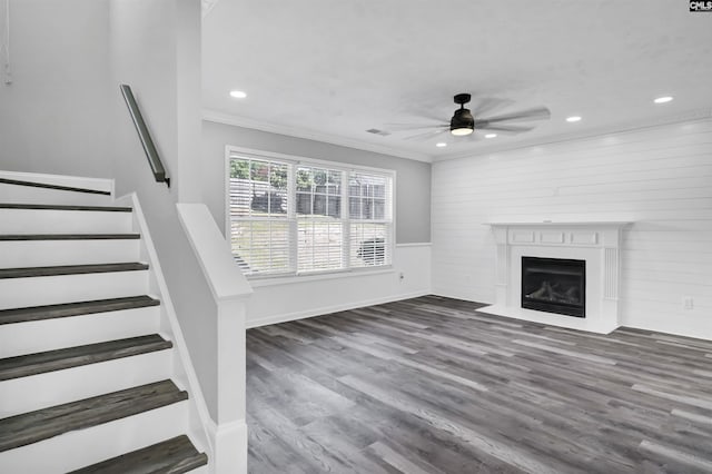 unfurnished living room with crown molding, ceiling fan, stairs, recessed lighting, and wood finished floors