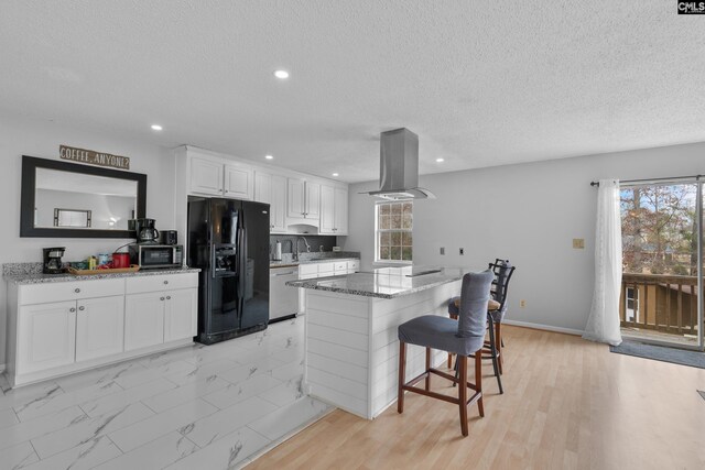 kitchen featuring white cabinets, stainless steel appliances, plenty of natural light, and island range hood