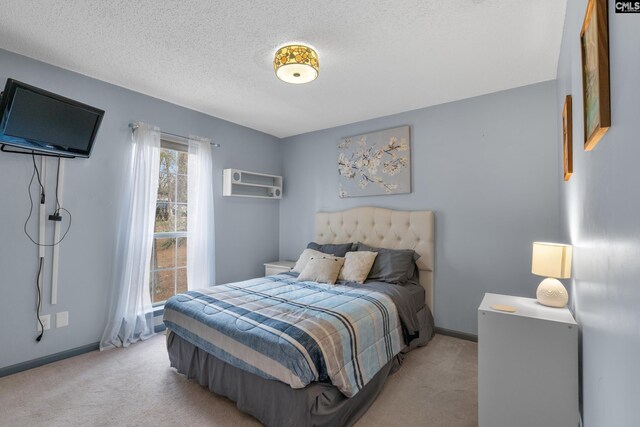 bedroom featuring baseboards, a textured ceiling, and light carpet
