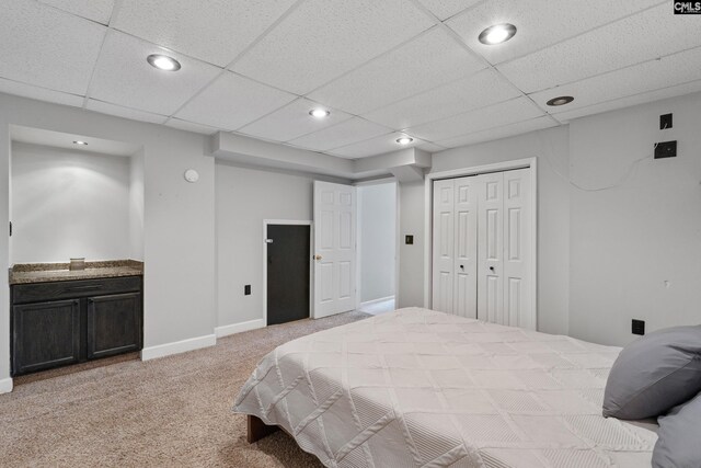bedroom featuring recessed lighting, a closet, and light carpet