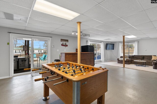 game room with baseboards and a paneled ceiling