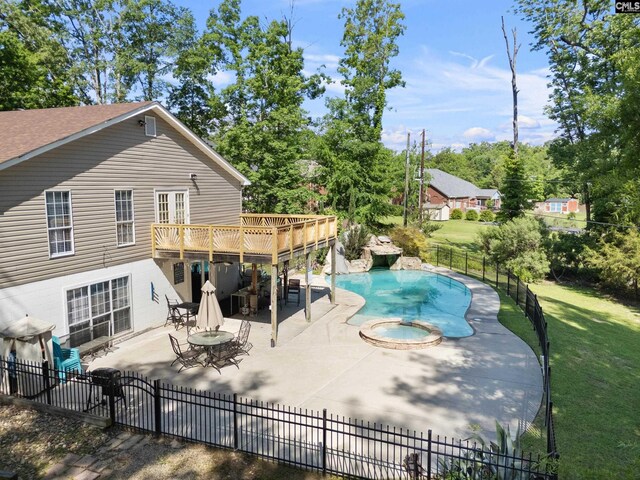 view of swimming pool featuring a yard, fence private yard, a deck, and a patio area