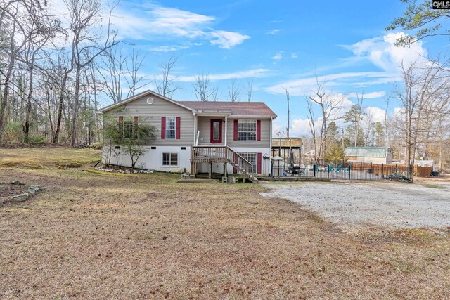 view of front of property with fence and a front lawn