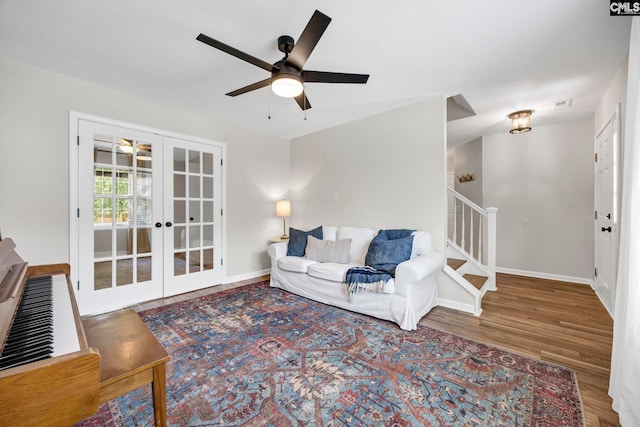 living area featuring french doors, baseboards, ceiling fan, and wood finished floors
