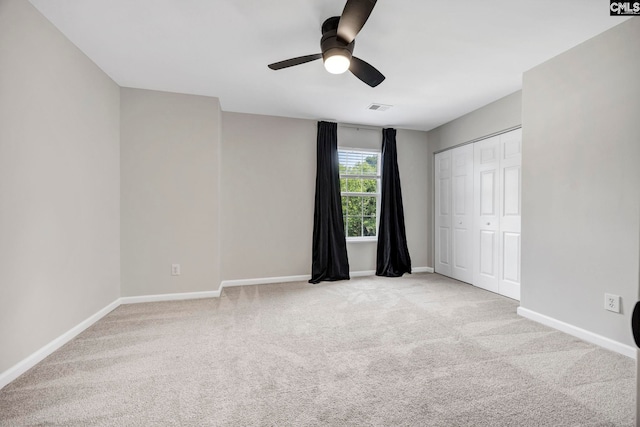 unfurnished bedroom featuring baseboards, light carpet, and visible vents