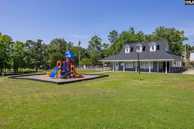 community play area with fence and a lawn