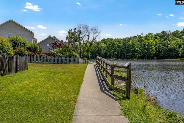 view of yard with a water view and fence