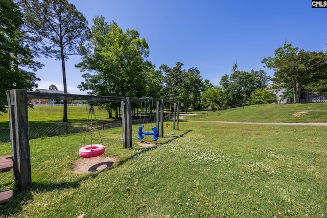 view of community with fence and a lawn
