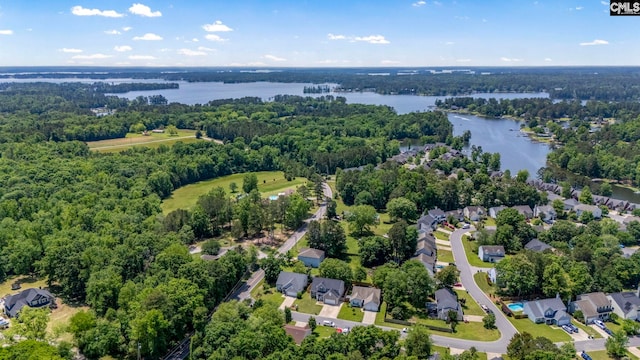 drone / aerial view with a water view, a residential view, and a forest view