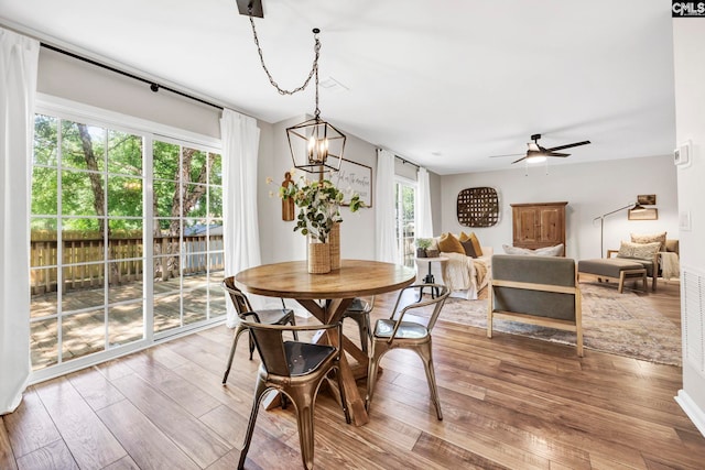 dining space featuring wood-type flooring and a ceiling fan