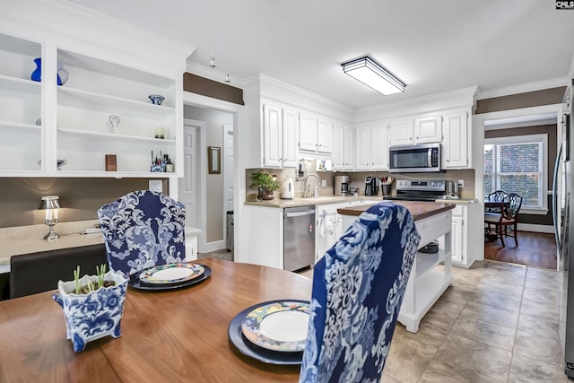 kitchen featuring crown molding, white cabinetry, open shelves, and appliances with stainless steel finishes