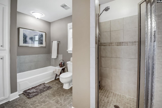 bathroom with toilet, visible vents, a shower stall, and a garden tub