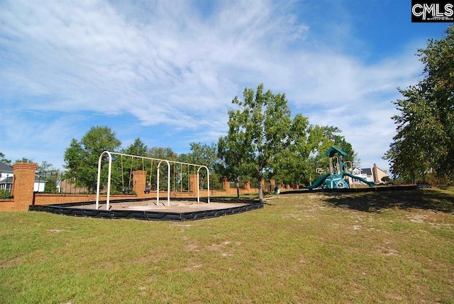 community jungle gym featuring a yard
