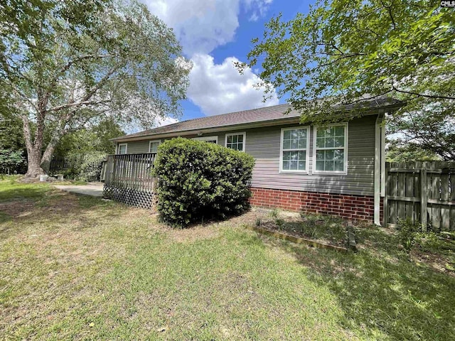 exterior space with a lawn and fence