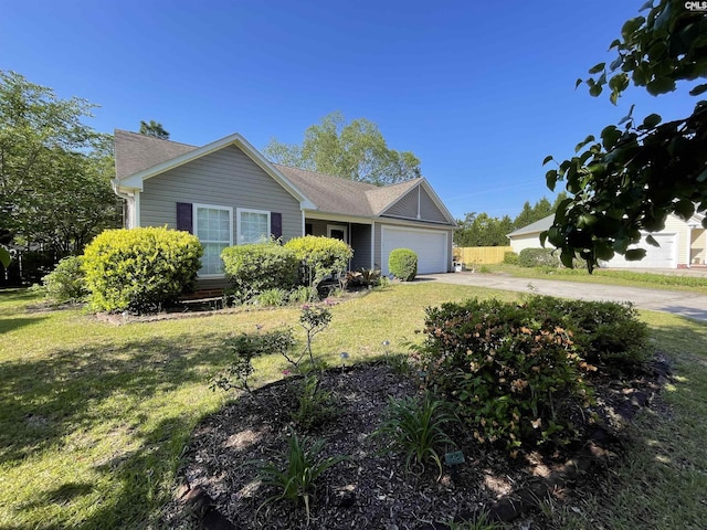 ranch-style house with an attached garage, driveway, and a front yard