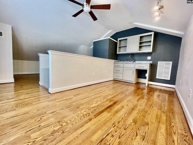 bonus room featuring ceiling fan, light wood finished floors, baseboards, lofted ceiling, and visible vents